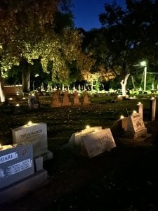 Graves illuminated by solar candles. 